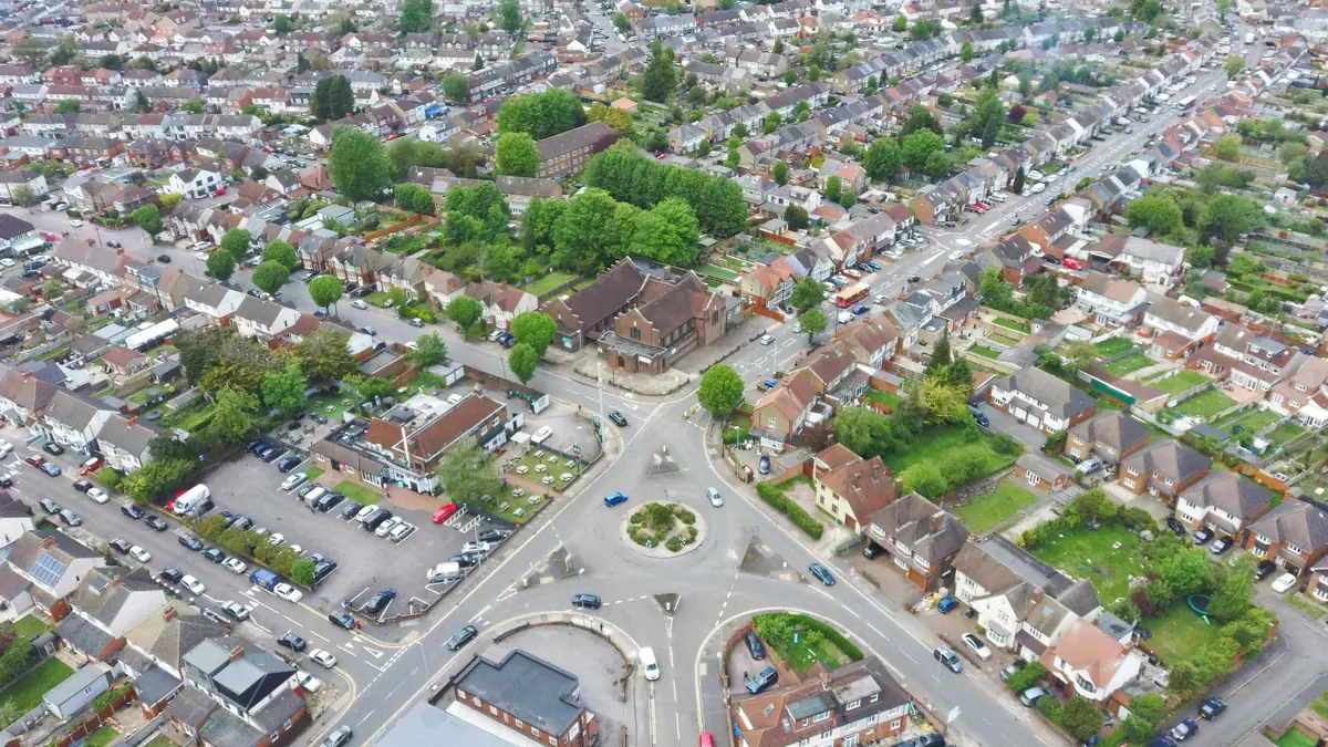 An aerial view of suburban streets around a roundabout.