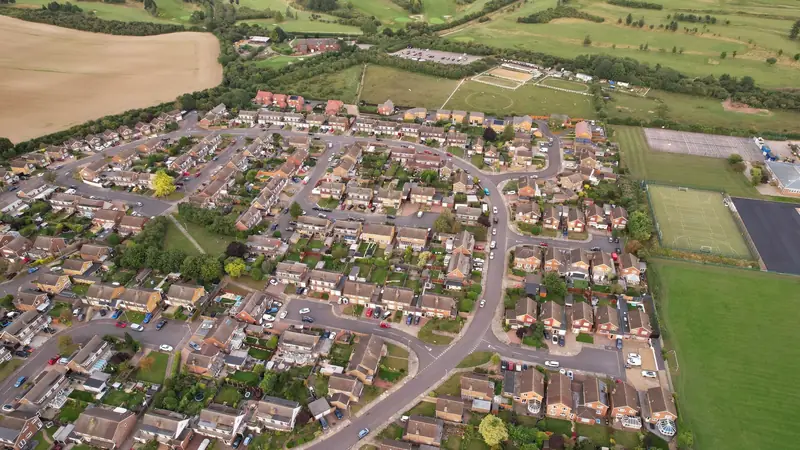 An aerial view of a modern housing estate beside open fields