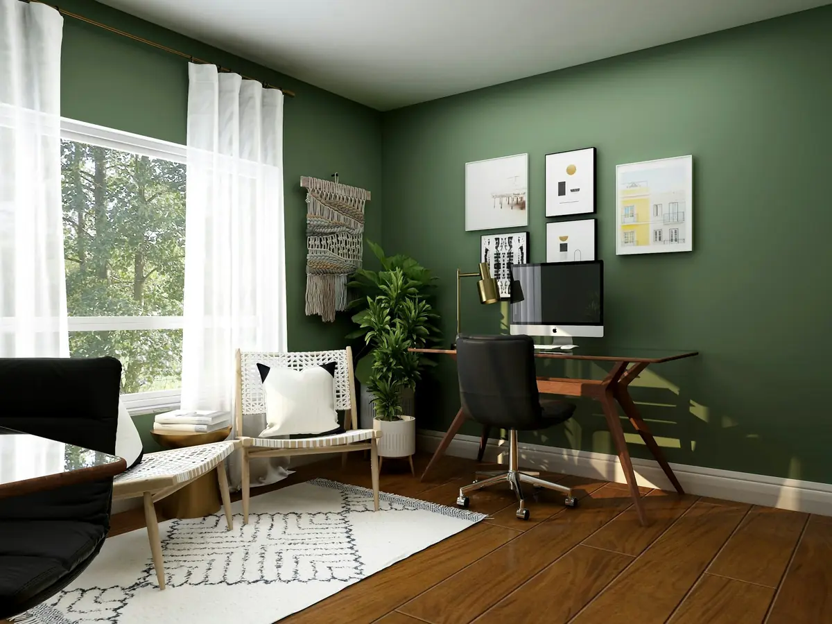 A home office with a green wall and a desk by the window.