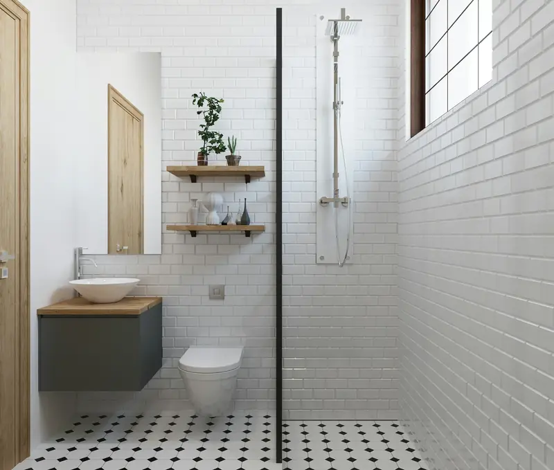 A white tiled shower room with a walk-in shower, basin and toilet