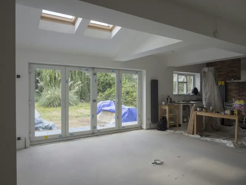 A garage conversion nearing the end, with new glass folding doors onto the garden and roof windows above