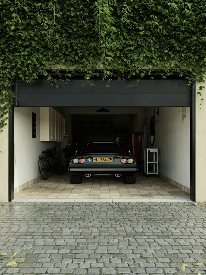 A single garage with the door open and a classic car parked inside
